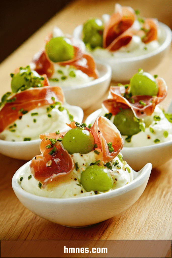Cuillères apéritives de fromage fouetté au raisin vert et jambon cru, décorées de ciboulette