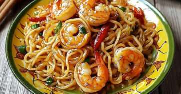 Nouilles sautées aux crevettes épicées avec légumes croquants et sauce asiatique brillante servies dans un bol