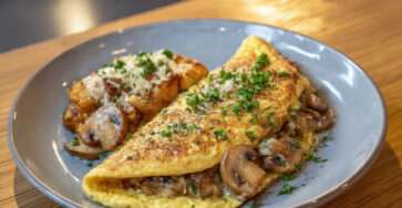 Omelette paysanne aux champignons ail et fromage fondant servie bien chaude